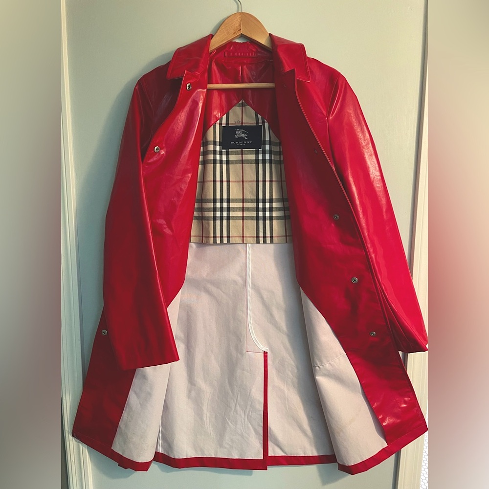 Red Burberry raincoat. Burberry print on the inside of jacket and collar.